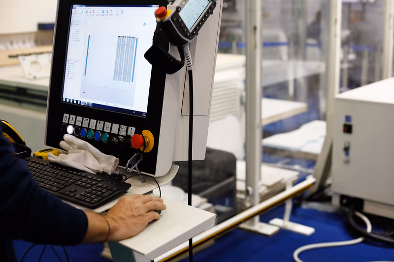 Operator controlling modern industrial equipment for precise cutting